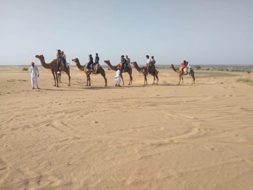 Sunset camel safari ride across the sand dunes in Osian, Rajasthan