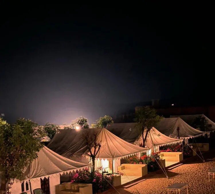 Desert camping tents illuminated under the night sky in Osian, Rajasthan