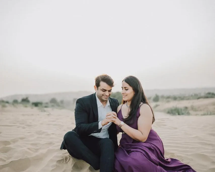 Romantic couple photoshoot on open golden sand dunes in Osian, Rajasthan