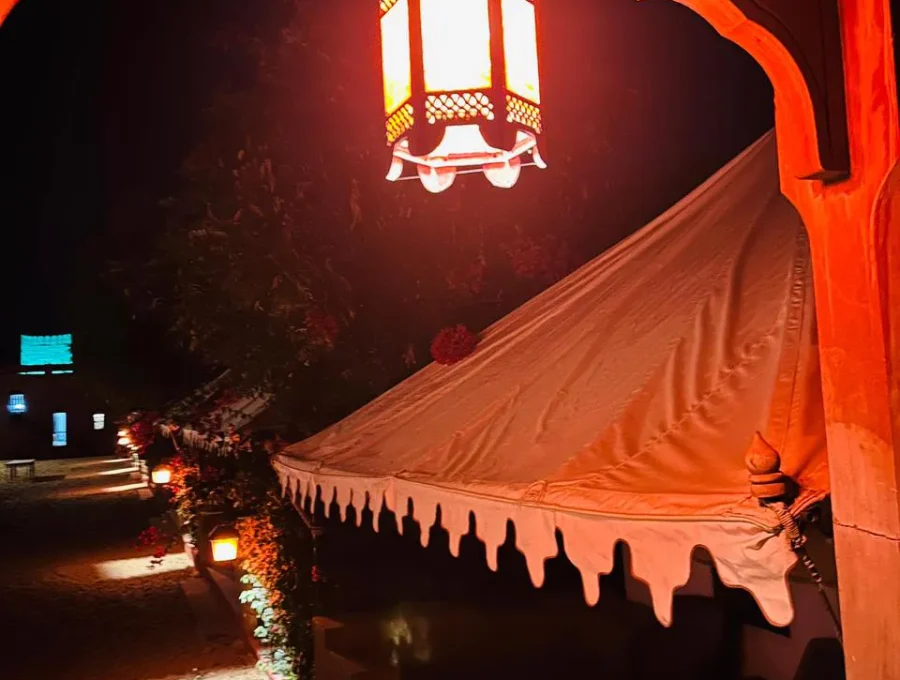 Desert tent interior with traditional canopy and ambient lighting in Osian
