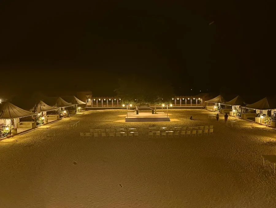 Desert camp dinner tables with warm lanterns and desert night ambiance in Osian