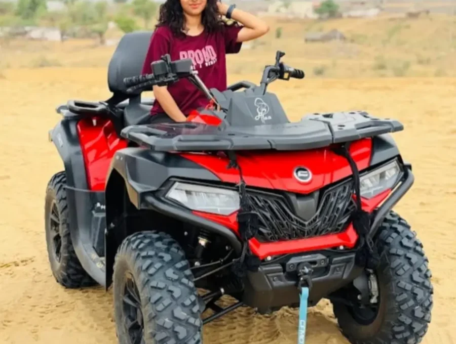 All-terrain vehicle ATV quad bike parked on golden sand dunes in Osian with rider