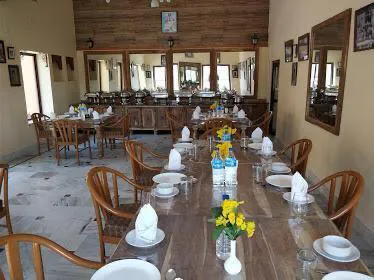 Long dining tables set for lunch inside dining hall at Desert Safari Osian base camp