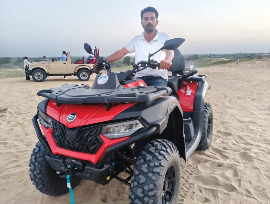 All-terrain quad bike ATV safari riding across the sand dunes in Osian, Rajasthan