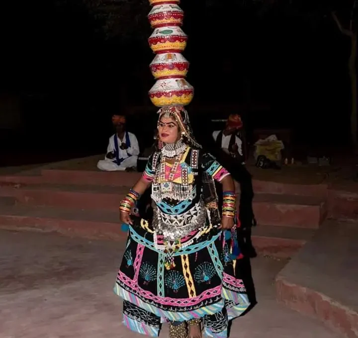 Rajasthani folk dancer performing in traditional colorful attire in Osian